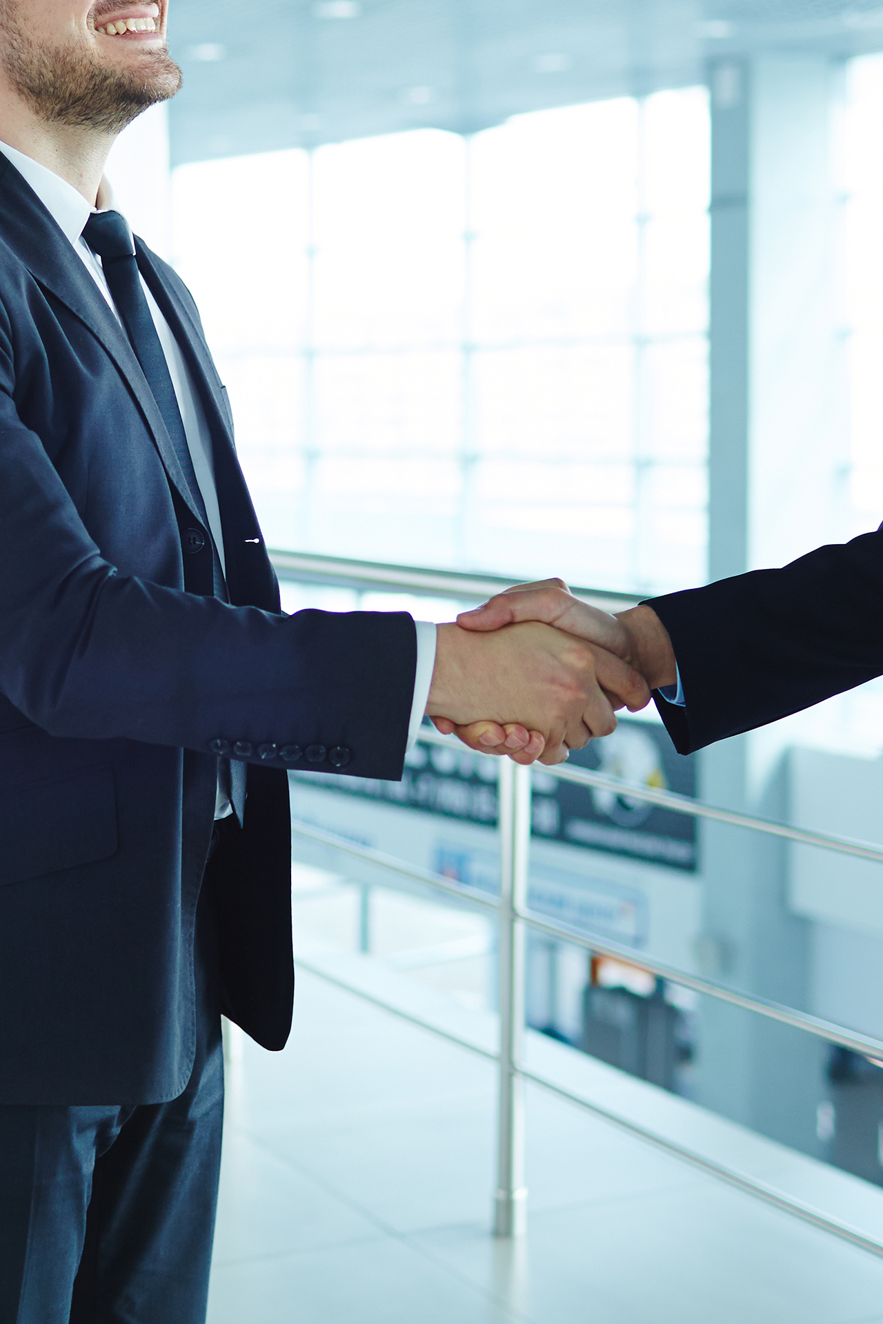 man smiling as he shakes hands