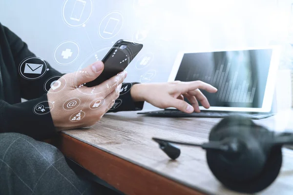 Zoomed image of man using VoIP telephone and mobile