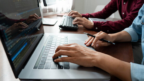 Men sitting side by side on laptop