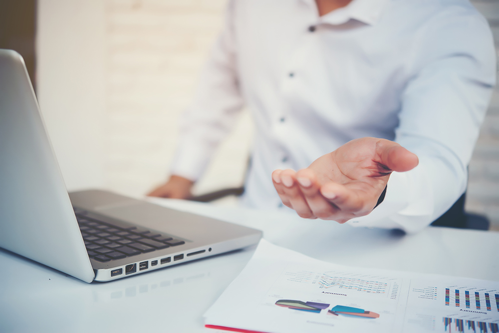 man at desk with data files